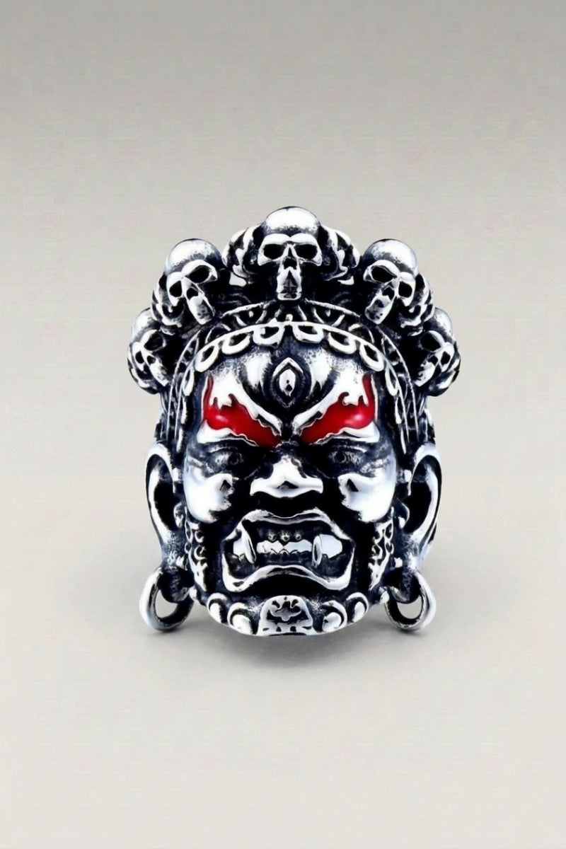 Bague 'Shining' — chevalière en masque peint aux couleurs vives, yeux rouges et sourcils marqués, photo produit sur fond gris clair