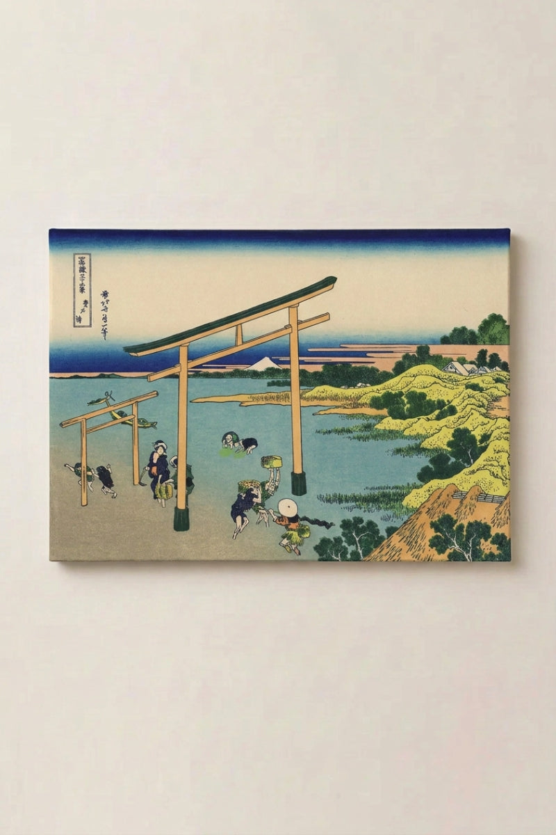 Estampe japonaise 'Torii' en panneau encadré sur mur beige — torii planté sur une grève au crépuscule ocre, pêcheurs dans l'eau basse et Fuji à l'horizon