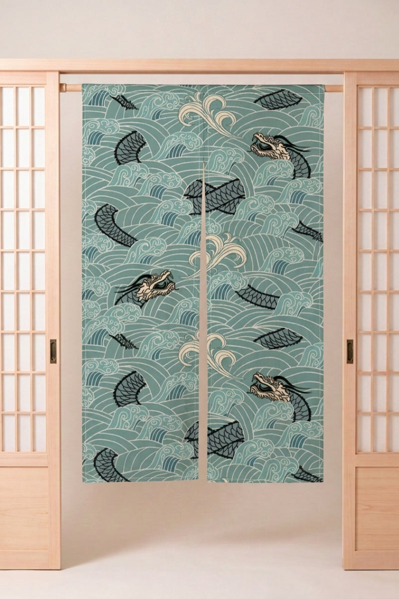 Noren japonais 'Ryu-jin' suspendu dans l'encadrement d'une porte en bois clair — poissons sombres nageant dans des remous blancs sur fond vert d'eau pâle
