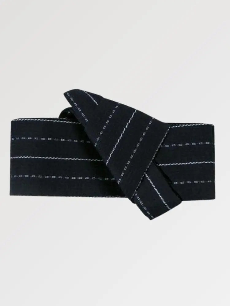 Ceinture obi 'Nagano' pliée à plat sur fond gris, extrémités repliées l'une sur l'autre — fond bleu nuit parcouru de fines rayures blanches en pointillé