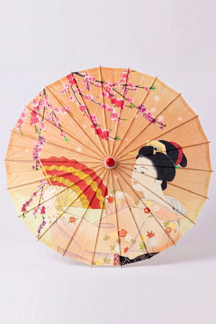 Ombrelle japonaise 'Kuki-Fan' vue de dessus, ouverte à plat — toile orange semée d'éventails ouverts et d'une grue en vol, baleines rayonnant depuis le moyeu