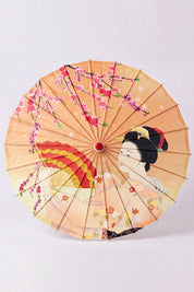 Ombrelle japonaise 'Kuki-Fan' vue de dessus, ouverte à plat — toile orange semée d'éventails ouverts et d'une grue en vol, baleines rayonnant depuis le moyeu