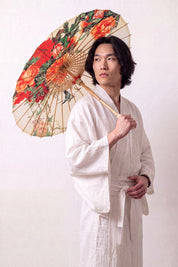 Ombrelle japonaise 'Asatsuyu' ouverte et tenue par un mannequin en kimono blanc — toile crème à grandes fleurs orange et rouges