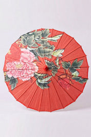 Ombrelle japonaise 'Aka' vue de dessus, ouverte à plat — toile rouge profond à pivoines et feuillage vert, baleines rayonnant depuis le moyeu