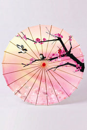 Ombrelle japonaise 'Sakura Fleuri' vue de dessous — toile rose dégradée à branche sombre et fleurs de cerisier, armature apparente