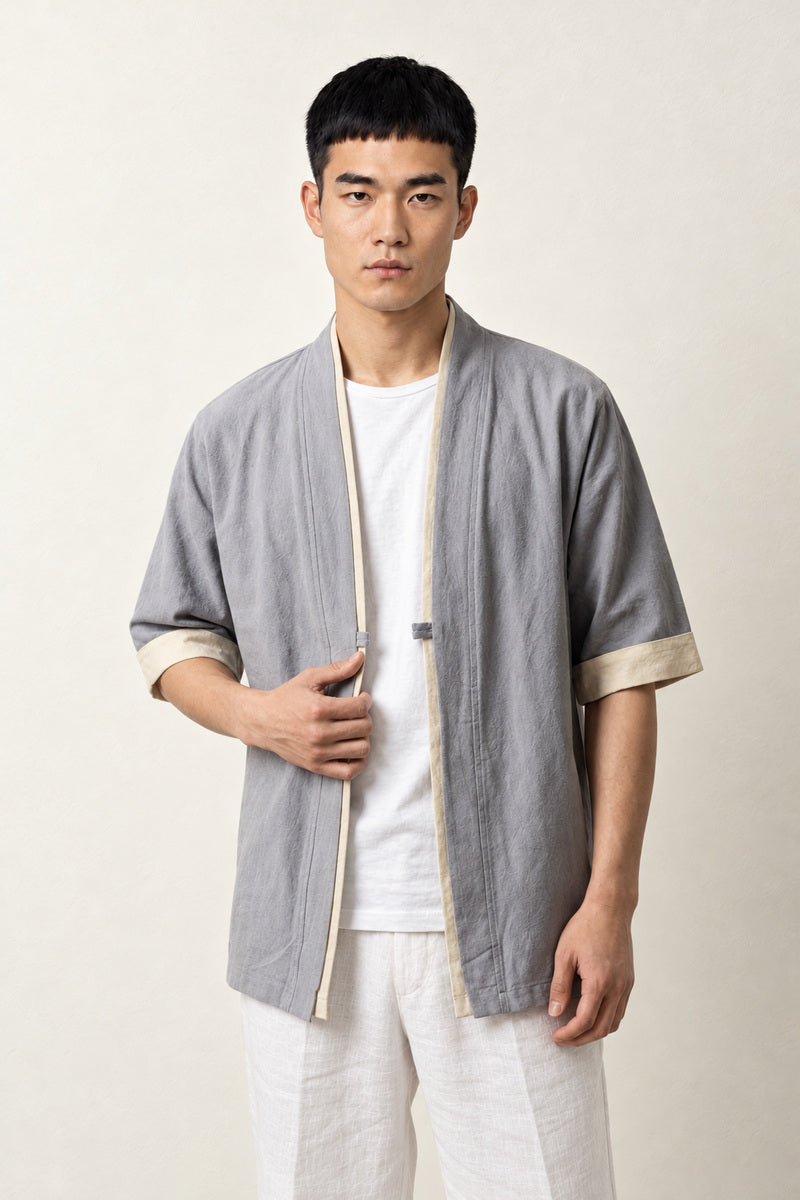 Veste style japonais homme Gris Hideki coton liseré blanc manches courtes col en V, porté par un homme, vue de face.