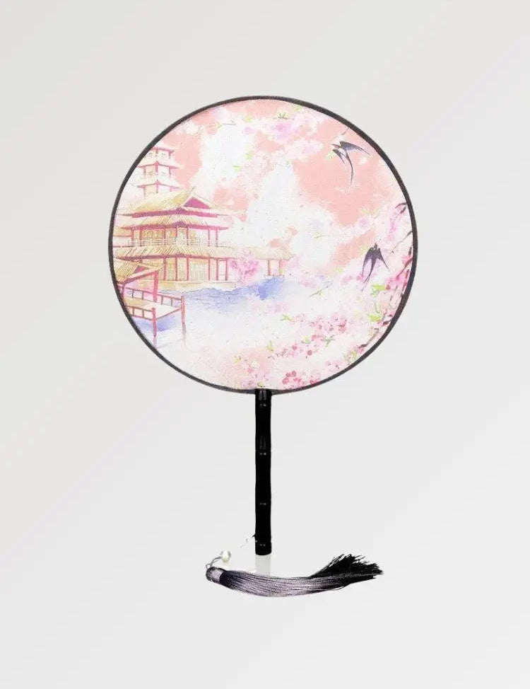 Un éventail japonais rond au motif d'un temple traditionnel